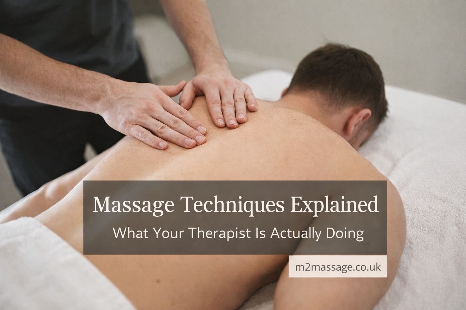 Male massage therapist performing effleurage technique on upper back during professional massage in Peterborough